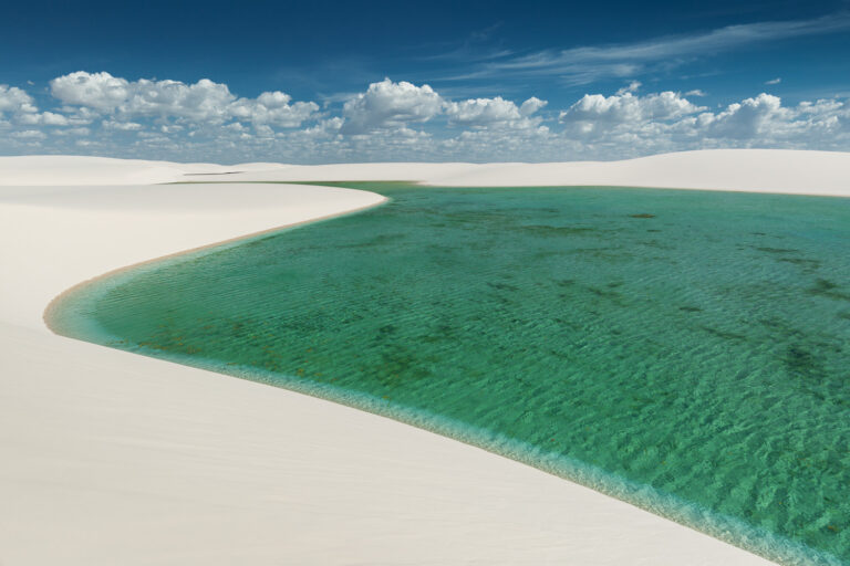 White sand dunes and colorful lagoons formed during the rainy season.