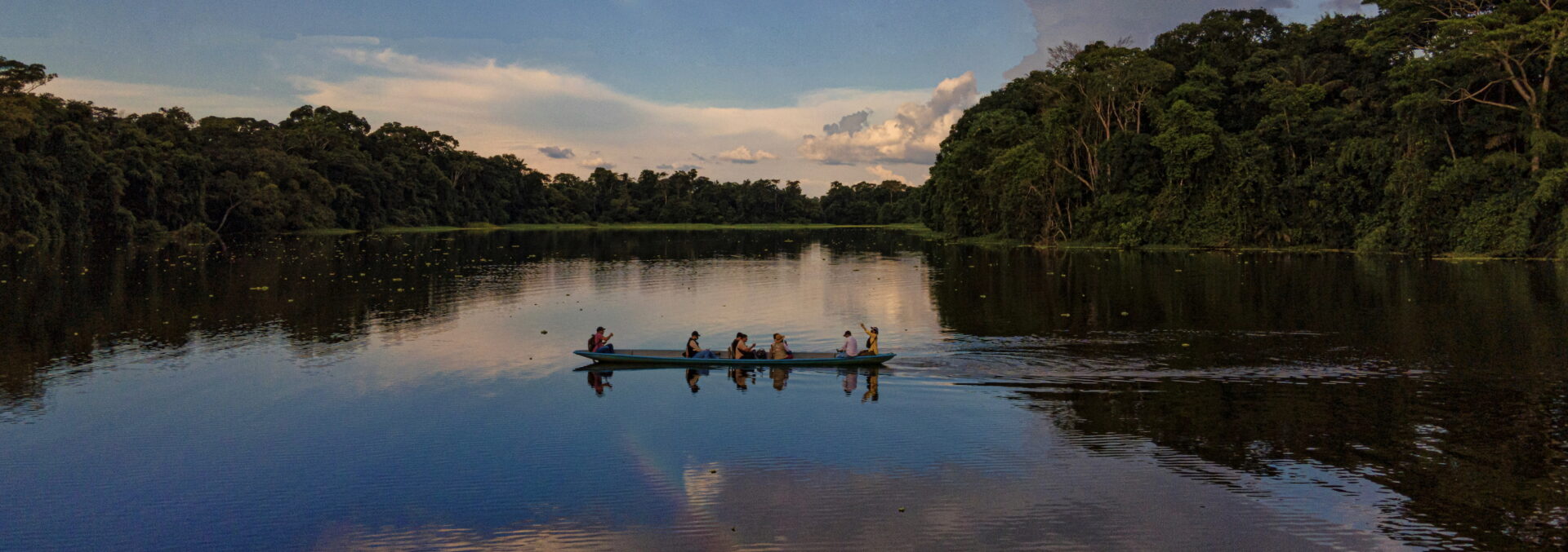 Conscious Travel A bot in a river in the Amazon Rainforest